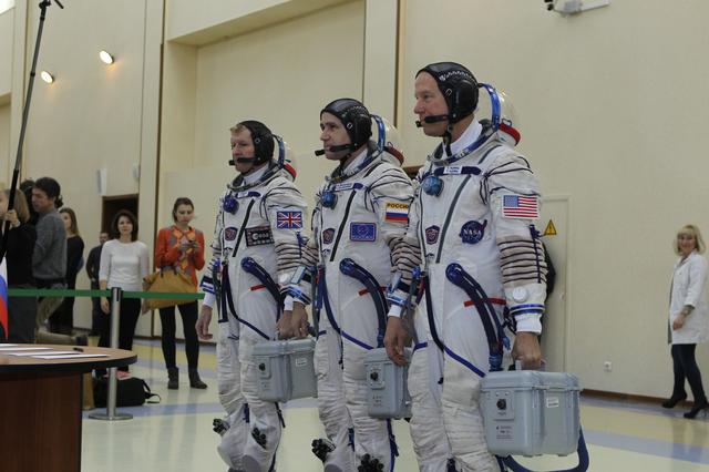 NASA image: At the Gagarin Cosmonaut Training Center in Star City, Russia, Expedition 46-47 crewmembers Tim Peake of the European Space Agency (left), Yuri Malenchenko of the Russian Federal Space Agency (Roscosmos, center) and Tim Kopra of NASA (right) report for their qualification exams Nov. 20. The trio will launch Dec. 15 on their Soyuz TMA-19M spacecraft Dec. 15 from the Baikonur Cosmodrome in Kazakhstan for a six-month mission on the International Space Station..NASA/Seth Marcantel