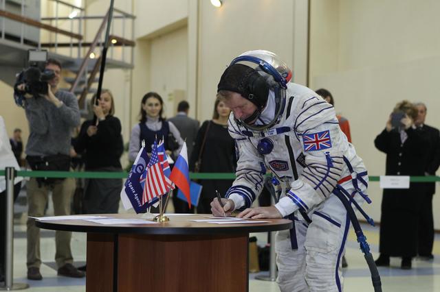 NASA image: At the Gagarin Cosmonaut Training Center in Star City, Russia, Expedition 46-47 crewmember Tim Peake of the European Space Agency signs in for his qualification exam Nov. 20. Along with Yuri Malenchenko of the Russian Federal Space Agency (Roscosmos) and Tim Kopra of NASA, Peake will launch Dec. 15 on the Soyuz TMA-19M spacecraft Dec. 15 from the Baikonur Cosmodrome in Kazakhstan for a six-month mission on the International Space Station..NASA/Seth Marcantel