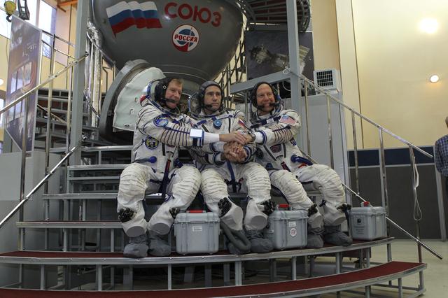 NASA image: At the Gagarin Cosmonaut Training Center in Star City, Russia, Expedition 46-47 crewmembers Tim Peake of the European Space Agency (left), Yuri Malenchenko of the Russian Federal Space Agency (Roscosmos, center) and Tim Kopra of NASA (right) pose for pictures at the start of their final qualification exam Nov. 20. The trio will launch Dec. 15 on their Soyuz TMA-19M spacecraft Dec. 15 from the Baikonur Cosmodrome in Kazakhstan for a six-month mission on the International Space Station..NASA/Seth Marcantel