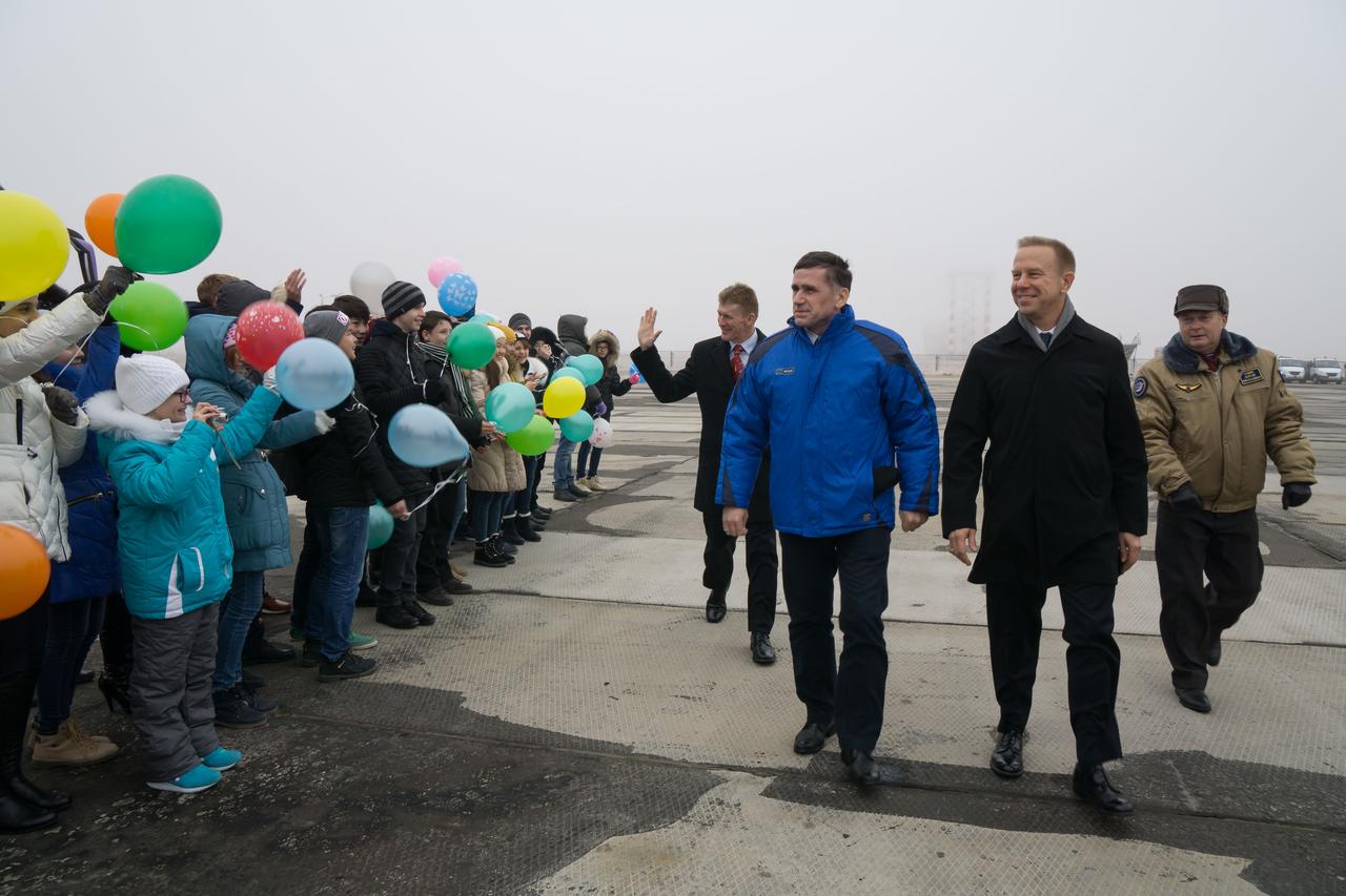 The Expedition 46-47 crewmembers arrive in Baikonur, Kazakhstan Nov. 30 for final pre-launch training following a flight from their training base at the Gagarin Cosmonaut Training Center in Star City, Russia and are greeted by school children. Tim Peake of the European Space Agency (left), Yuri Malenchenko of the Russian Federal Space Agency (Roscosmos, center) and Tim Kopra of NASA (right), will launch Dec. 15 on the Soyuz TMA-19M spacecraft for a six-month mission on the International Space Station.  NASA / Victor Zelentsov   