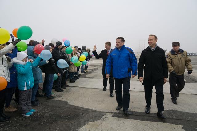 NASA image: The Expedition 46-47 crewmembers arrive in Baikonur, Kazakhstan Nov. 30 for final pre-launch training following a flight from their training base at the Gagarin Cosmonaut Training Center in Star City, Russia and are greeted by school children. Tim Peake of the European Space Agency (left), Yuri Malenchenko of the Russian Federal Space Agency (Roscosmos, center) and Tim Kopra of NASA (right), will launch Dec. 15 on the Soyuz TMA-19M spacecraft for a six-month mission on the International Space Station...NASA / Victor Zelentsov  .