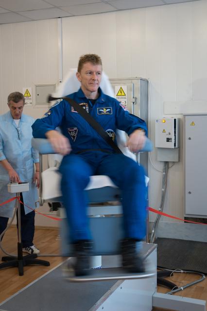 NASA image: At the Cosmonaut Hotel crew quarters in Baikonur, Kazakhstan, Expedition 46-47 crewmember Tim Peake of the European Space Agency took a turn in a spinning chair to test his vestibular system Dec. 9 as part of his pre-launch training. Peake, Yuri Malenchenko of the Russian Federal Space Agency (Roscosmos) and Tim Kopra of NASA will launch Dec. 15 on their Soyuz TMA-19M spacecraft for a six-month mission on the International Space Station...NASA/Victor Zelentsov.