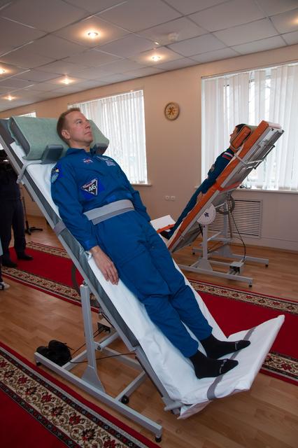 NASA image: At the Cosmonaut Hotel crew quarters in Baikonur, Kazakhstan, Expedition 46-47 crewmember Tim Kopra of NASA took a turn on a tilt table to test his vestibular system Dec. 9 as part of his pre-launch training. Kopra, Tim Peake of the European Space Agency and Yuri Malenchenko of the Russian Federal Space Agency will launch Dec. 15 on their Soyuz TMA-19M spacecraft for a six-month mission on the International Space Station...NASA/Victor Zelentsov.