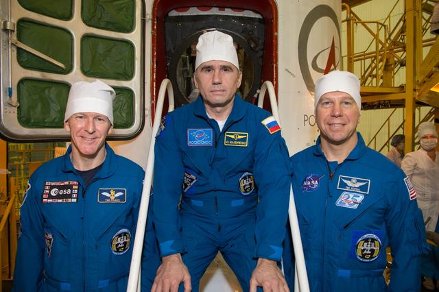 NASA image: In the Integration Facility at the Baikonur Cosmodrome in Kazakhstan, Expedition 46-47 crewmembers Tim Peake of the European Space Agency (left), Yuri Malenchenko of the Russian Federal Space Agency (Roscosmos, center) and Tim Kopra of NASA (right) pose for pictures Dec. 10 during a final fit check and inspection of the Soyuz spacecraft which will transport them to orbit. Kopra, Peake and Malenchenko will launch Dec. 15 on the Soyuz TMA-19M spacecraft for a six-month mission on the International Space Station...NASA/Victor Zelentsov.