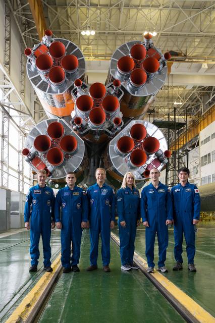 NASA image: In the Integration Facility at the Baikonur Cosmodrome in Kazakhstan, the prime and backup Expedition 46-47 crewmembers posed for pictures Dec. 10 in front of the first stage of the Soyuz booster rocket during final pre-launch training. From left to right are prime crewmembers Tim Peake of the European Space Agency, Yuri Malenchenko of the Russian Federal Space Agency (Roscosmos) and Tim Kopra of NASA and backup crewmembers Kate Rubins of NASA, Anatoly Ivanishin of Roscosmos and Takuya Onishi of the Japan Aerospace Exploration Agency. Kopra, Peake and Malenchenko will launch Dec. 15 on the Soyuz TMA-19M spacecraft for a six-month mission on the International Space Station...NASA/Victor Zelentsov.
