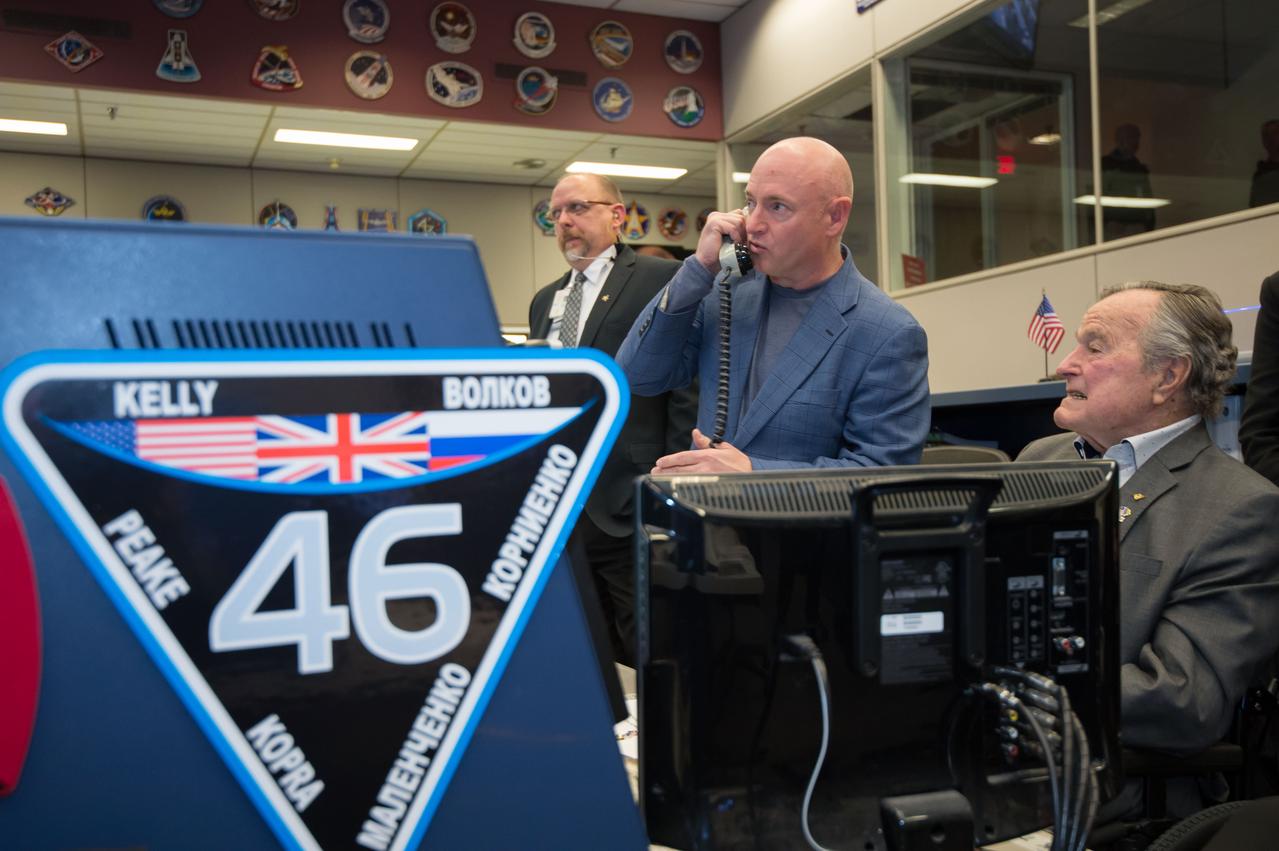 Former President George H.W. Bush paid a visit to NASA's Johnson Space Center to speak with Expedition 46 Commander Scott Kelly and Flight Engineer Tim Kopra and take a tour of the Space Vehicle Mockup Facility. Kelly’s twin brother, Mark Kelly and his wife, former Congresswoman Gabrielle Giffords were also present. Photo Date: February 5, 2016. Location: Building 30 - ISS Flight Control Room. Photographer: Robert Markowitz