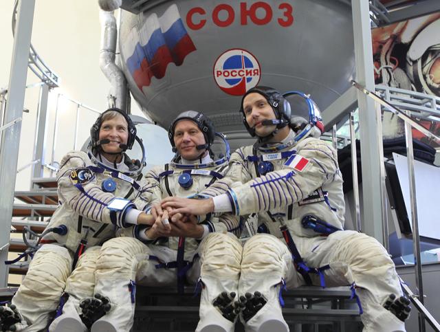 NASA image: At the Gagarin Cosmonaut Training Center in Star City, Russia, Expedition 48-49 backup crewmembers Peggy Whitson of NASA (left), Oleg Novitskiy of Roscosmos (center) and Thomas Pesquet of the European Space Agency (right) pose for pictures in front of a Soyuz simulator during Soyuz qualification exams May 26. They are serving as the backups to prime crewmembers Kate Rubins of NASA, Takuya Onishi of the Japan Aerospace Exploration Agency and Anatoly Ivanishin of Roscosmos, who will launch June 24 on the Soyuz MS-01 spacecraft from the Baikonur Cosmodrome in Kazakhstan for a four-month mission on the International Space Station...NASA/Stephanie Stoll.