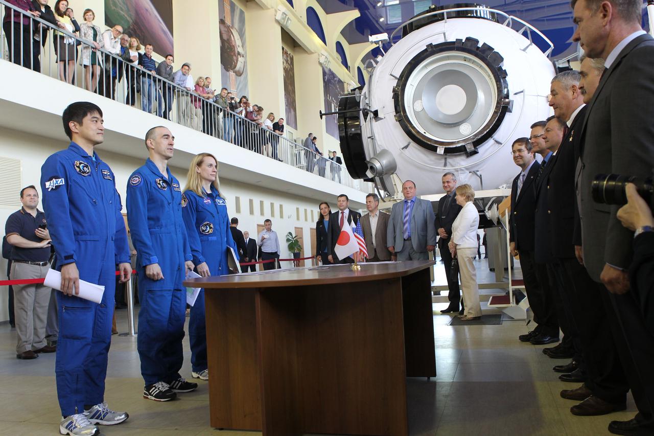 At the Gagarin Cosmonaut Training Center in Star City, Russia, Expedition 48-49 prime crewmembers Takuya Onishi of the Japan Aerospace Exploration Agency (left), Anatoly Ivanishin of Roscosmos (center) and Kate Rubins of NASA (right) report to officials May 26 at the start of final qualification exams. Rubins, Onishi and Ivanishin will launch June 24 on the Soyuz MS-01 spacecraft from the Baikonur Cosmodrome in Kazakhstan for a four-month mission on the International Space Station.  NASA/Stephanie Stoll 