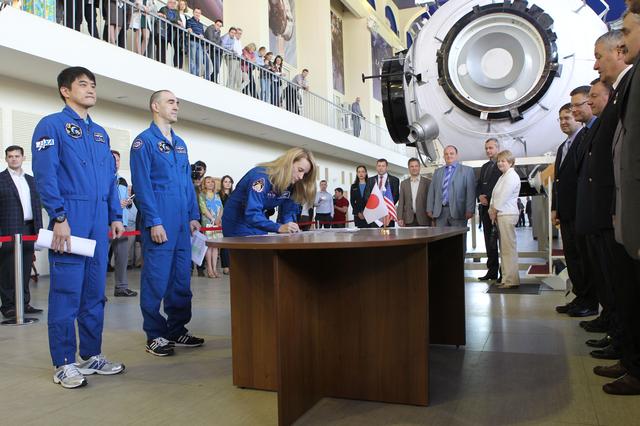 NASA image: At the Gagarin Cosmonaut Training Center in Star City, Russia, Expedition 48-49 prime crewmember Kate Rubins of NASA signs in for the start of final qualification exams May 26 as her crewmates, Takuya Onishi of the Japan Aerospace Exploration Agency (left) and Anatoly Ivanishin of Roscosmos (center) look on. Rubins, Onishi and Ivanishin will launch June 24 on the Soyuz MS-01 spacecraft from the Baikonur Cosmodrome in Kazakhstan for a four-month mission on the International Space Station...NASA/Stephanie Stoll.