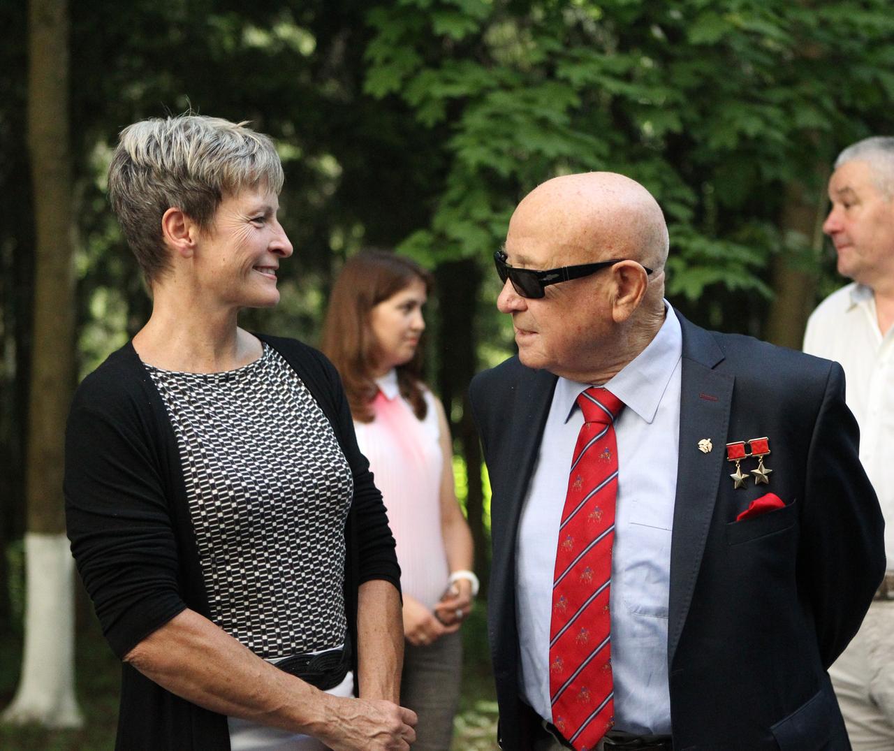 At the Gagarin Cosmonaut Training Center in Star City, Russia, ISS Expedition 48-49 backup crewmember Peggy Whitson of NASA (left) shares a lighthearted moment June 24 with legendary cosmonaut Alexey Leonov, the first human to walk in space, as Whitson and other crewmembers departed for their launch site at the Baikonur Cosmodrome in Kazakhstan. Prime crewmembers Kate Rubins of NASA, Anatoly Ivanishin of Roscosmos and Takuya Onishi of the Japan Aerospace Exploration Agency will launch July 7 from the Baikonur Cosmodrome in Kazakhstan on the Soyuz MS-01 spacecraft for a planned four-month mission on the International Space Station.  NASA/Stephanie Stoll 