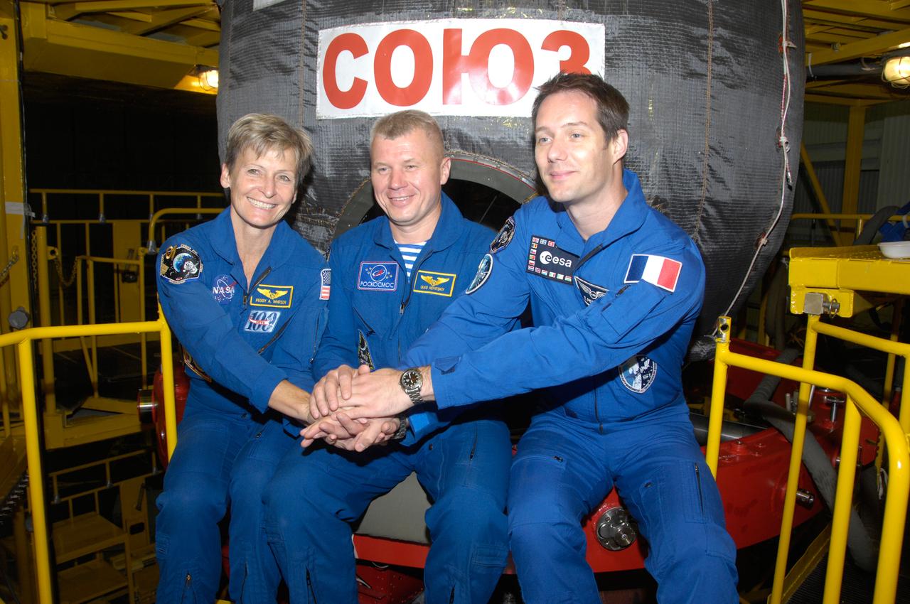In the Integration Facility at the Baikonur Cosmodrome in Kazakhstan, Expedition 48-49 backup crewmembers Peggy Whitson of NASA (left), Oleg Novitskiy of Roscosmos (center) and Thomas Pesquet of the European Space Agency (right) pose for pictures June 25 in front of the Soyuz MS-01 spacecraft during a “fit check” dress rehearsal activity. Prime crewmembers Kate Rubins of NASA, Anatoly Ivanishin of Roscosmos and Takuya Onishi of the Japan Aerospace Exploration Agency will launch on July 7, Baikonur time, on the Soyuz MS-01 for a planned four-month mission on the International Space Station.  NASA/Alexander Vysotsky 