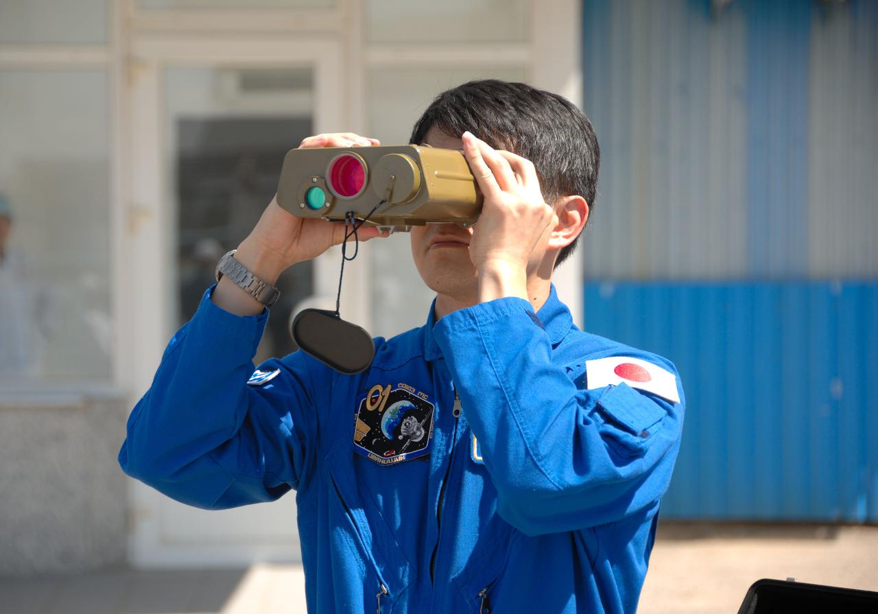 Outside the Integration Facility at the Baikonur Cosmodrome in Kazakhstan, Expedition 48-49 crewmember Takuya Onishi of the Japan Aerospace Exploration Agency tries out a pair of binoculars June 25 as he prepares for launch July 7, Baikonur time, on the Soyuz MS-01 spacecraft with Kate Rubins of NASA and Anatoly Ivanishin of Roscosmos for a planned four-month mission on the International Space Station.  NASA/Alexander Vysotsky 
