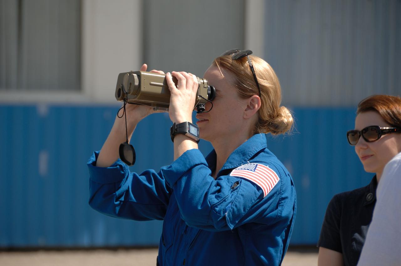 Outside the Integration Facility at the Baikonur Cosmodrome in Kazakhstan, Expedition 48-49 crewmember Kate Rubins of NASA tries out a pair of binoculars June 25 as she prepares for launch July 7, Baikonur time, on the Soyuz MS-01 spacecraft with Takuya Onishi of the Japan Aerospace Exploration Agency and Anatoly Ivanishin of Roscosmos for a planned four-month mission on the International Space Station.  NASA/Alexander Vysotsky 
