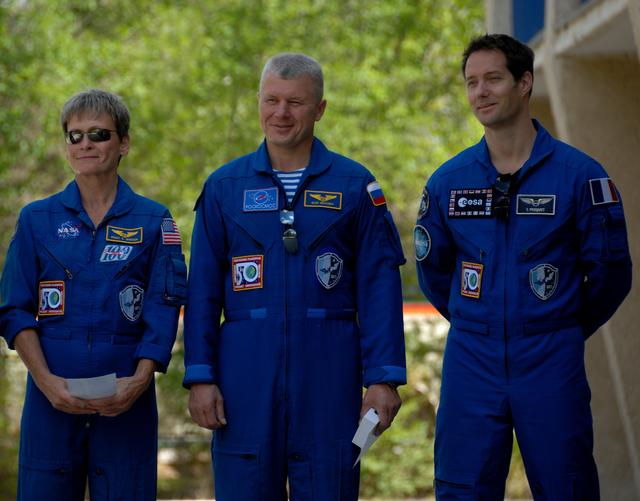 NASA image: Outside their Cosmonaut Hotel crew quarters in Baikonur, Kazakhstan, Expedition 48-49 backup crewmembers Peggy Whitson of NASA (left), Oleg Novitskiy of Roscosmos (center) and Thomas Pesquet of the European Space Agency (right) listen to remarks June 26 during the traditional raising of the American, Russian, Japanese and Kazakh flags. Prime crewmembers Kate Rubins of NASA, Anatoly Ivanishin of Roscosmos and Takuya Onishi of the Japan Aerospace Exploration Agency will launch on July 7, Baikonur time, on the Soyuz MS-01 spacecraft for a planned four-month mission on the International Space Station...NASA/Alexander Vysotsky.