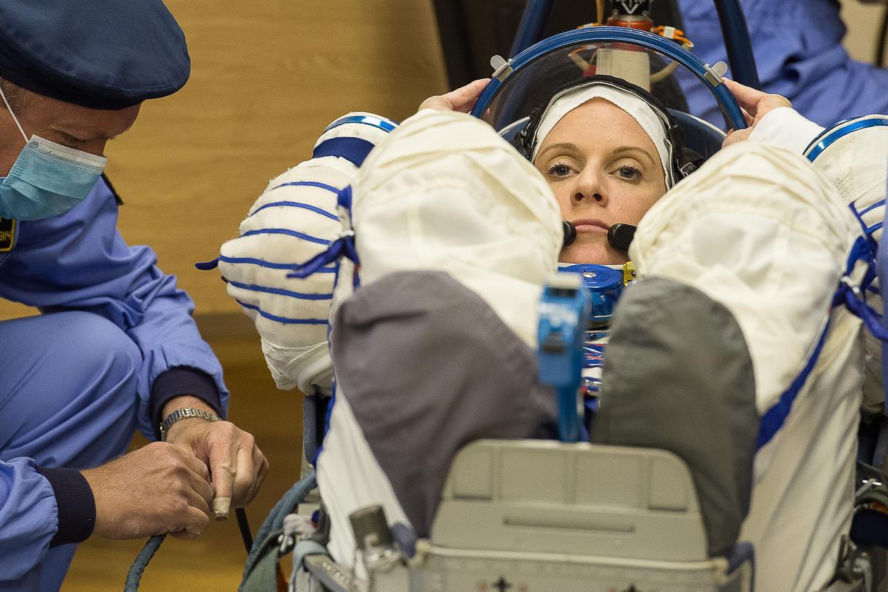 In the Integration Facility at the Baikonur Cosmodrome in Kazakhstan, Expedition 48-49 crewmember Kate Rubins of NASA conducts a leak check of her Russian Sokol launch and entry suit June 25 as part of the preparations for launch with Anatoly Ivanishin of Roscosmos and Takuya Onishi of the Japan Aerospace Exploration Agency on July 7, Baikonur time, on the Soyuz MS-01 spacecraft for a planned four-month mission on the International Space Station.  GCTC/Andrei Shelepin 