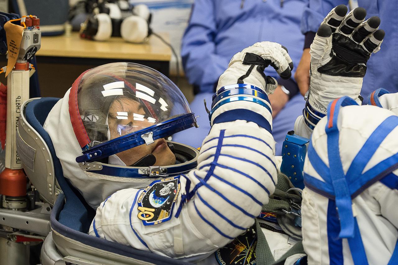 In the Integration Facility at the Baikonur Cosmodrome in Kazakhstan, Expedition 48-49 crewmember Takuya Onishi of the Japan Aerospace Exploration Agency conducts a leak check of his Russian Sokol launch and entry suit June 25 as part of the preparations for launch with Anatoly Ivanishin of Roscosmos and Kate Rubins of NASA on July 7, Baikonur time, on the Soyuz MS-01 spacecraft for a planned four-month mission on the International Space Station.  GCTC/Andrei Shelepin 