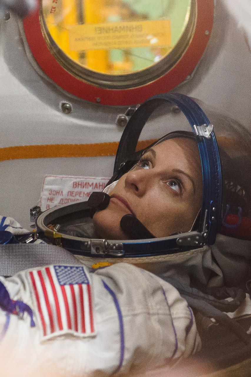 In the Integration Facility at the Baikonur Cosmodrome in Kazakhstan, Expedition 48-49 crewmember Kate Rubins of NASA conducts a “fit check” familiarization aboard the Soyuz MS-01 spacecraft June 25 as part of the preparations for launch with Anatoly Ivanishin of Roscosmos and Takuya Onishi of the Japan Aerospace Exploration Agency on July 7, Baikonur time for a planned four-month mission on the International Space Station.  GCTC/Andrei Shelepin 