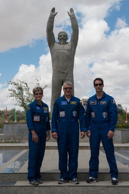 NASA image: During a tour of the town in Baikonur, Kazakhstan June 26, Expedition 48-49 backup crewmembers Peggy Whitson of NASA (left), Oleg Novitskiy of Roscosmos (center) and Thomas Pesquet of the European Space Agency (right) pose for pictures in front of a statue of Yuri Gagarin, the first human to fly in space. Whitson, Novitskiy and Pesquet are backups to Kate Rubins of NASA, Anatoly Ivanishin of Roscosmos and Takuya Onishi of the Japan Aerospace Exploration Agency, who are preparing for launch on July 7, Baikonur time, on the Soyuz MS-01 spacecraft for a planned four-month mission on the International Space Station...GCTC/Andrei Shelepin.