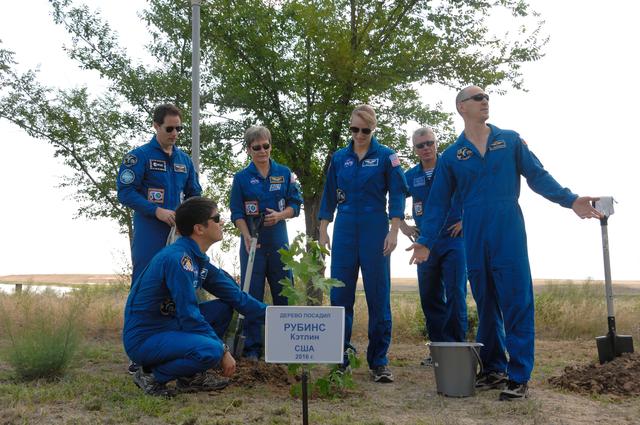 NASA image: At the Cosmonaut Hotel in Baikonur, Kazakhstan, Expedition 48-49 crewmember Kate Rubins of NASA (third from left, standing) admires a tree she planted in her name in traditional pre-launch activities June 30 as her crewmates surround her. They include Takuya Onishi of the Japan Aerospace Exploration Agency (crouching), and backup crewmembers Thomas Pesquet of the European Space Agency (standing, left), Peggy Whitson of NASA (standing, second from the left), and Oleg Novitskiy (standing, second from the right) and prime crewmember Anatoly Ivanishin (right). Rubins, Ivanishin and Onishi will launch July 7, Baikonur time, on the Soyuz MS-01 spacecraft for a planned four-month mission on the International Space Station...NASA/Alexander Vysotsky.