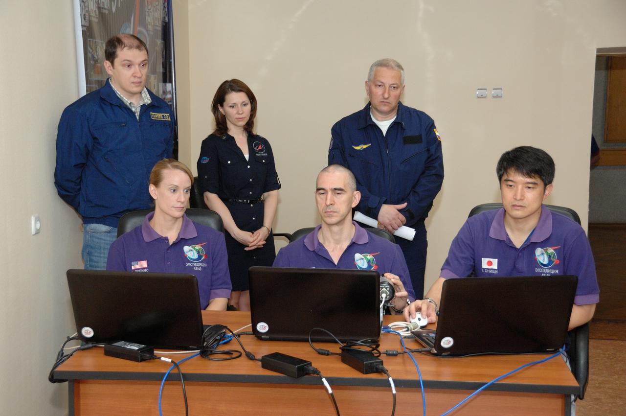 At the Cosmonaut Hotel in Baikonur, Kazakhstan, Expedition 48-49 crewmembers Kate Rubins of NASA (left), Anatoly Ivanishin of Roscosmos (center) and Takuya Onishi of the Japan Aerospace Exploration Agency (right) conduct rendezvous rehearsals on a laptop computer simulator June 30 as instructors look on. Rubins, Ivanishin and Onishi will launch July 7, Baikonur time, on the Soyuz MS-01 spacecraft for a planned four-month mission on the International Space Station.  NASA/Alexander Vysotsky 