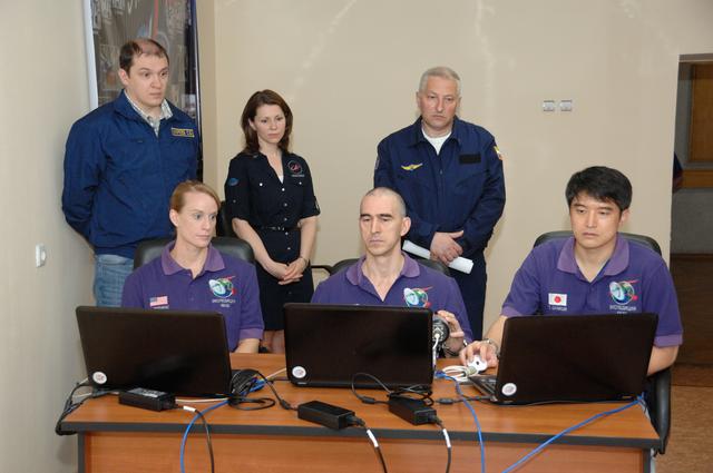 NASA image: At the Cosmonaut Hotel in Baikonur, Kazakhstan, Expedition 48-49 crewmembers Kate Rubins of NASA (left), Anatoly Ivanishin of Roscosmos (center) and Takuya Onishi of the Japan Aerospace Exploration Agency (right) conduct rendezvous rehearsals on a laptop computer simulator June 30 as instructors look on. Rubins, Ivanishin and Onishi will launch July 7, Baikonur time, on the Soyuz MS-01 spacecraft for a planned four-month mission on the International Space Station...NASA/Alexander Vysotsky.