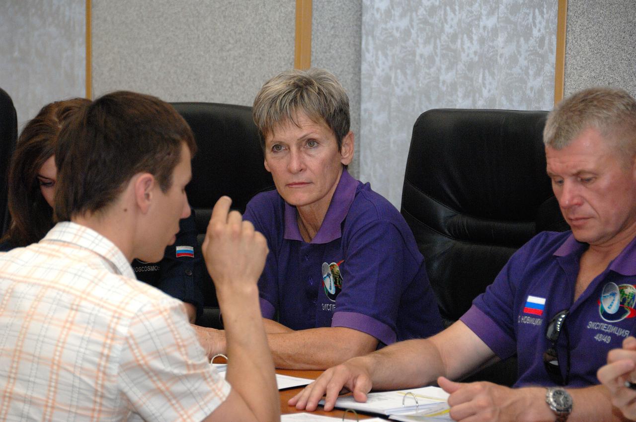 At the Cosmonaut Hotel in Baikonur, Kazakhstan, Expedition 48-49 backup crewmember Peggy Whitson of NASA listens to a rendezvous instructor June 30 as her crewmate, Oleg Novitskiy of Roscosmos (right) reviews documents. They are backups to the prime crewmembers, Kate Rubins of NASA, Anatoly Ivanishin of Roscosmos and Takuya Onishi of the Japan Aerospace Exploration Agency, who will launch July 7, Baikonur time, on the Soyuz MS-01 spacecraft for a planned four-month mission on the International Space Station.  NASA/Alexander Vysotsky 