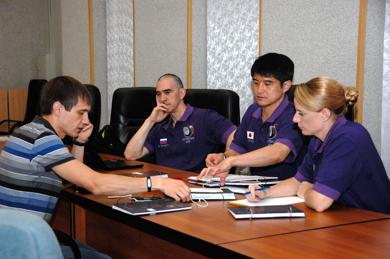 At the Cosmonaut Hotel in Baikonur, Kazakhstan, Expedition 48-49 crewmembers Anatoly Ivanishin of Roscosmos (second from left), Takuya Onishi of the Japan Aerospace Exploration Agency (second from right) and Kate Rubins of NASA (far right) listen to a rendezvous instructor June 30 during pre-launch training. Rubins, Ivanishin and Onishi will launch July 7, Baikonur time, on the Soyuz MS-01 spacecraft for a planned four-month mission on the International Space Station.  NASA/Alexander Vysotsky 