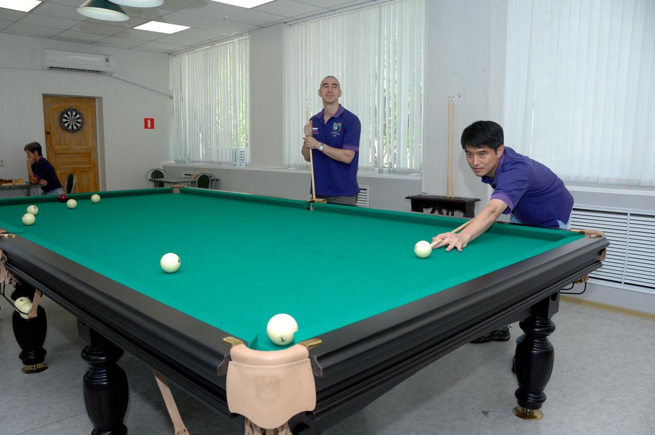 At the Cosmonaut Hotel in Baikonur, Kazakhstan, Expedition 48-49 crewmember Takuya Onishi of the Japan Aerospace Exploration Agency (right) tries his hand at billiards June 30 during pre-launch activities as his crewmate, Anatoly Ivanishin of Roscosmos looks on. In the background on the left, backup crewmember Peggy Whitson of NASA participates in a game of chess. Onishi, Ivanishin and Kate Rubins of NASA will launch July 7, Baikonur time, on the Soyuz MS-01 spacecraft for a planned four-month mission on the International Space Station.  NASA/Alexander Vysotsky 