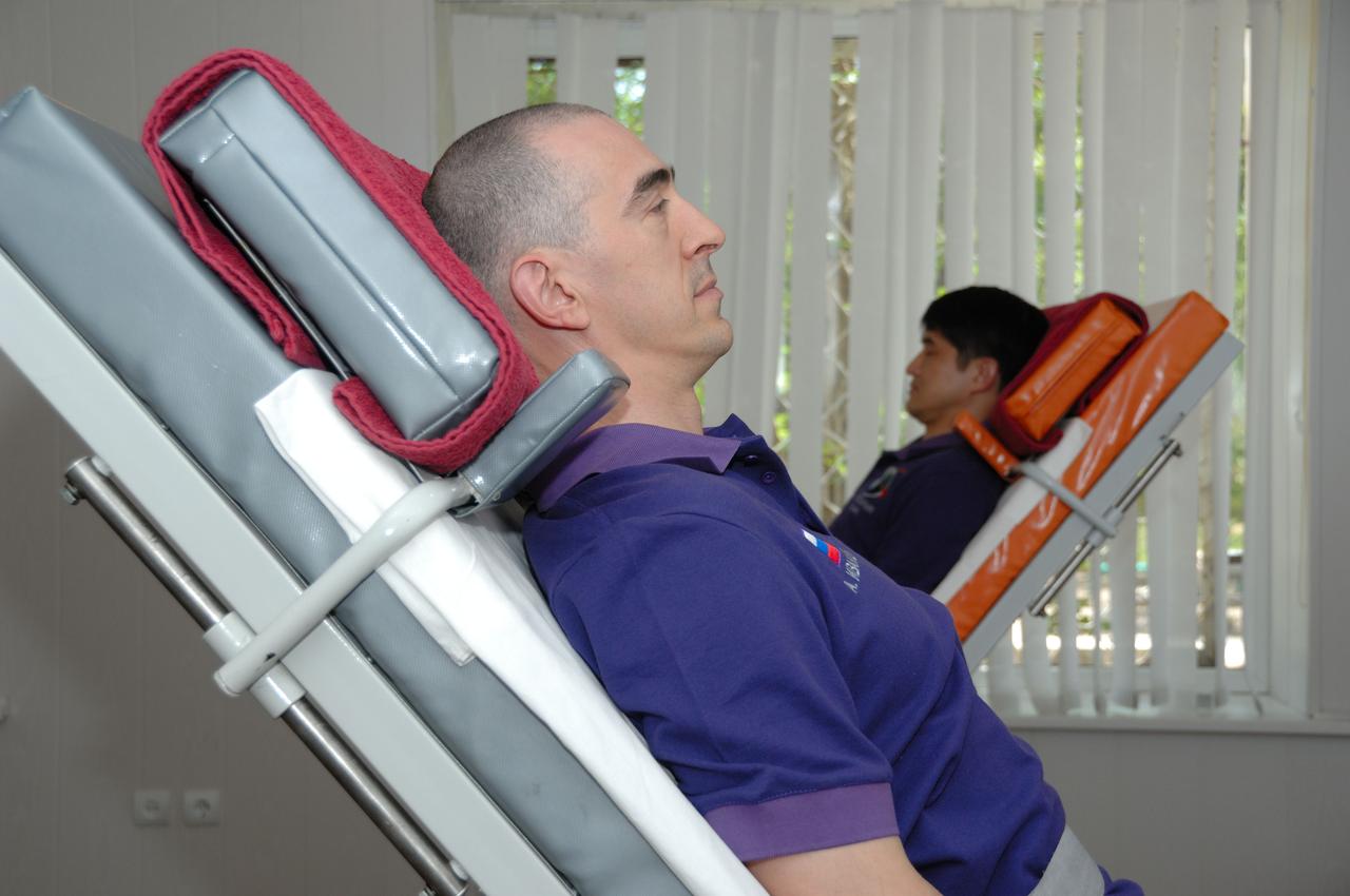 At the Cosmonaut Hotel in Baikonur, Kazakhstan, Expedition 48-49 crewmembers Anatoly Ivanishin of Roscosmos (foreground) and Takuya Onishi of the Japan Aerospace Exploration Agency conduct tests of their vestibular system on tilt tables June 30 as part of pre-launch activities. They and Kate Rubins of NASA will launch July 7, Baikonur time, on the Soyuz MS-01 spacecraft for a planned four-month mission on the International Space Station.  NASA/Alexander Vysotsky 