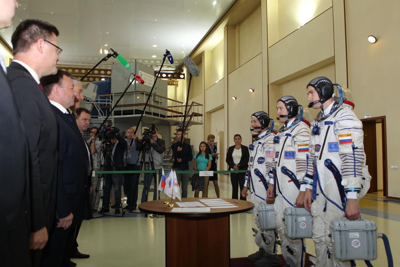 At the Gagarin Cosmonaut Training Center in Star City, Russia, Expedition 49-50 backup crewmembers Mark Vande Hei of NASA (right, far left) and Alexander Misurkin (right, center) and Nikolai Tikhonov (right, far right) of Roscosmos report to officials Aug. 30 at the start of final qualification exams. They are serving as backups to prime crewmembers Shane Kimbrough of NASA and Andrey Borisenko and Sergey Ryzhikov of Roscosmos who will launch on Sept. 24 (Kazakh time) on their Soyuz MS-02 vehicle from the Baikonur Cosmodrome in Kazakhstan for a five-month mission on the International Space Station. NASA/Stephanie Stoll