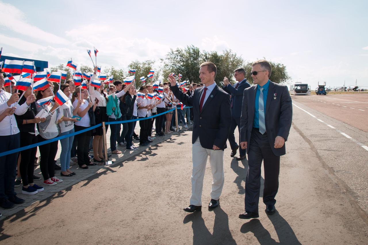 Expedition 49 crewmembers Sergey Ryzhikov of Roscosmos (left), Shane Kimbrough of NASA (center) and Andrey Borisenko of Roscosmos (right) are greeted by school children Sept. 8 in Baikonur, Kazakhstan after they arrived on a flight from their base at the Gagarin Cosmonaut Training Center in Star City, Russia for final pre-launch training. The trio will launch on Sept. 24, Kazakh time on the Soyuz MS-02 spacecraft for a five-month mission on the International Space Station.  NASA/Victor Zelentsov 