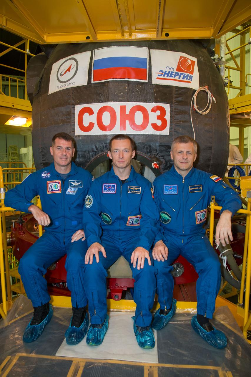 At the Integration Facility at the Baikonur Cosmodrome in Kazakhstan, Expedition 49 crewmembers Shane Kimbrough of NASA (left) and Sergey Ryzhikov (center) and Andrey Borisenko (right) of Roscosmos pose for pictures Sept. 9 in front of their Soyuz MS-02 spacecraft during a pre-launch training fit check. Kimbrough, Ryzhikov and Borisenko will launch Sept. 24, Kazakh time on the Soyuz MS-02 vehicle for a five-month mission on the International Space Station.  NASA/Victor Zelentsov 