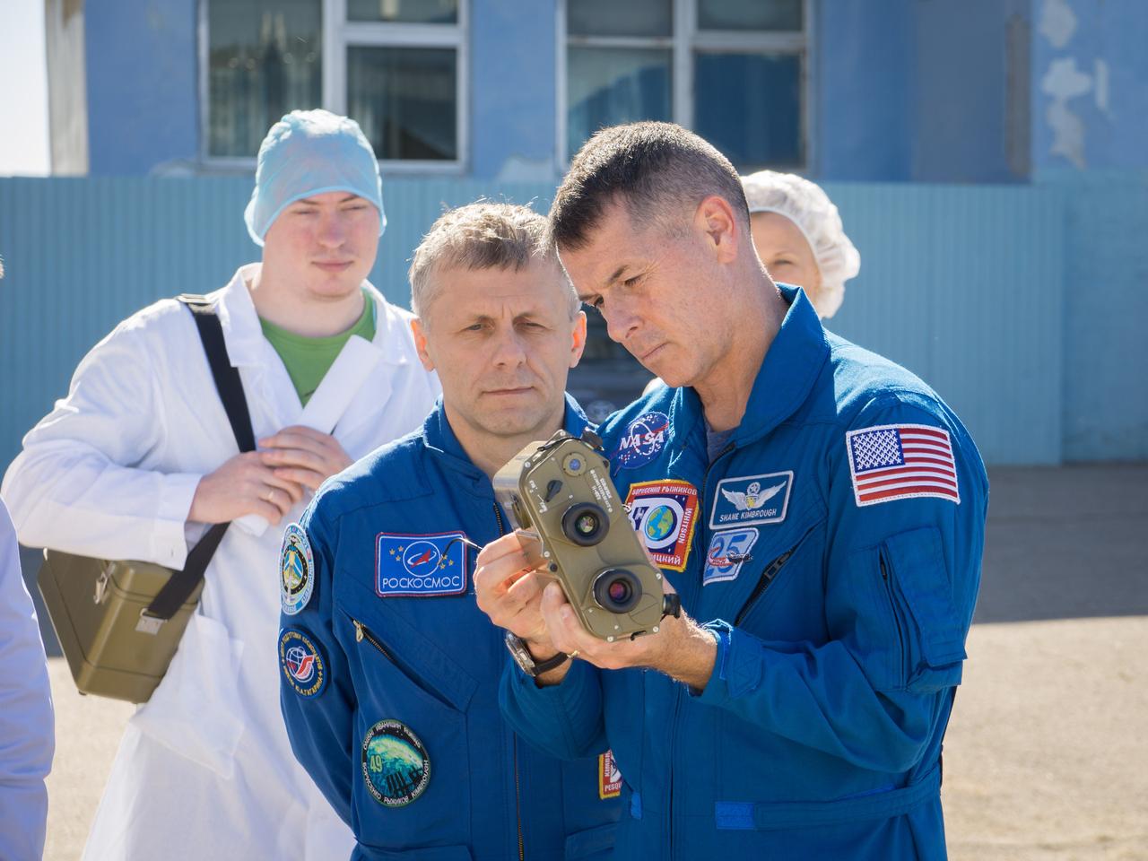 At the Integration Facility at the Baikonur Cosmodrome in Kazakhstan, Expedition 49 crewmember Shane Kimbrough of NASA (right) tests a pair of binoculars Sept. 9 as part of pre-launch training. Looking on is crewmate Andrey Borisenko of Roscosmos. Kimbrough, Borisenko and Sergey Ryzhikov of Roscosmos will launch Sept. 24, Kazakh time on the Soyuz MS-02 vehicle for a five-month mission on the International Space Station.  NASA/Victor Zelentsov 