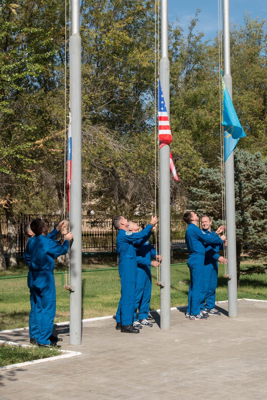 At their Cosmonaut Hotel crew quarters in Baikonur, Kazakhstan, the Expedition 49 prime and backup crewmembers participate in a traditional ceremony Sept. 10 to raise the flags of the U.S., Russia and Kazakhstan. Shane Kimbrough of NASA and Sergey Ryzhikov and Andrey Borisenko of Roscosmos will launch on Sept. 24, Kazakh time from the Baikonur Cosmodrome in Kazakhstan on the Soyuz MS-02 vehicle for a five-month mission on the International Space Station.  NASA/Victor Zelentsov 