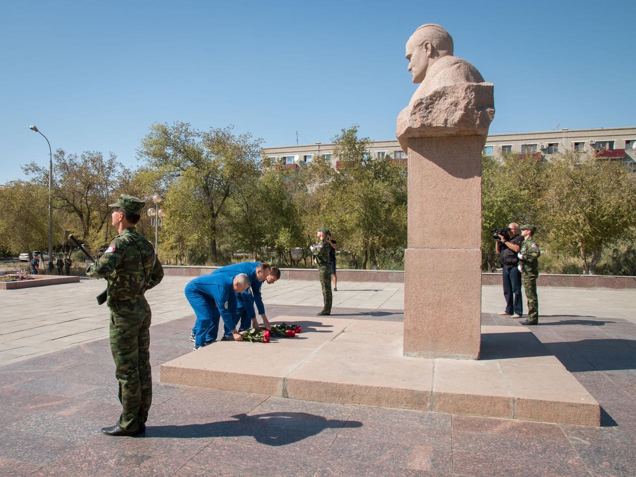 The Expedition 49 backup crewmembers lay flowers at the statue of Soviet rocket Great Designer Sergey Korolev during a tour of the city of Baikonur, Kazakhstan Sept. 10. From left to right in their flight suits are Mark Vande Hei of NASA and Alexander Misurkin and Nikolai Tikhonov of Roscosmos. They are serving as backups to Shane Kimbrough of NASA and Sergey Ryzhikov and Andrey Borisenko of Roscosmos, who will launch on Sept. 24, Kazakh time from the Baikonur Cosmodrome in Kazakhstan on the Soyuz MS-02 vehicle for a five-month mission on the International Space Station. NASA/Victor Zelentsov