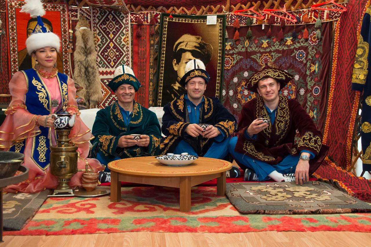 Wearing native garb, Expedition 49 backup crewmembers Mark Vande Hei of NASA and Alexander Misurkin and Nikolai Tikhonov of Roscosmos enjoy a cup a tea in a traditional Kazakh setting at a local museum Sept. 10 while on a tour of the city of Baikonur, Kazakhstan. They are serving as backups to Shane Kimbrough of NASA and Sergey Ryzhikov and Andrey Borisenko of Roscosmos, who will launch on Sept. 24, Kazakh time from the Baikonur Cosmodrome in Kazakhstan on the Soyuz MS-02 vehicle for a five-month mission on the International Space Station. NASA/Victor Zelentsov