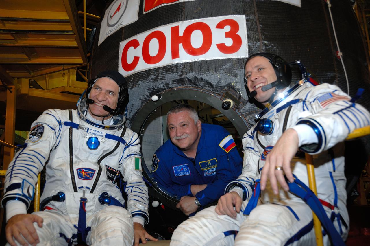 In the Integration Facility at the Baikonur Cosmodrome in Kazakhstan, Expedition 50-51 backup crewmember Fyodor Yurchikhin of the Russian Federal Space Agency (Roscosmos) peers out of the hatch to the Soyuz MS-03 spacecraft Nov. 2 during pre-launch training. Yurchikhin, Paolo Nespoli of the European Space Agency (left) and Jack Fischer of NASA (right) will back up the prime crewmembers, Peggy Whitson of NASA, Oleg Novitskiy of Roscosmos and Thomas Pesquet of the European Space Agency, who will launch Nov. 18, Baikonur time, for a six-month mission on the International Space Station. NASA/Alexander Vysotsky