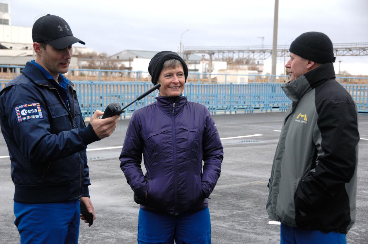 Outside the Integration Facility at the Baikonur Cosmodrome in Kazakhstan, Expedition 50-51 crewmembers Thomas Pesquet of the European Space Agency (left), Peggy Whitson of NASA (center) and Oleg Novitskiy of the Russian Federal Space Agency (Roscosmos, right) practice with a satellite phone Nov. 2 during pre-launch training. They will launch Nov. 18, Baikonur time, on the Soyuz MS-03 spacecraft for a six-month mission on the International Space Station. NASA/Alexander Vysotsky