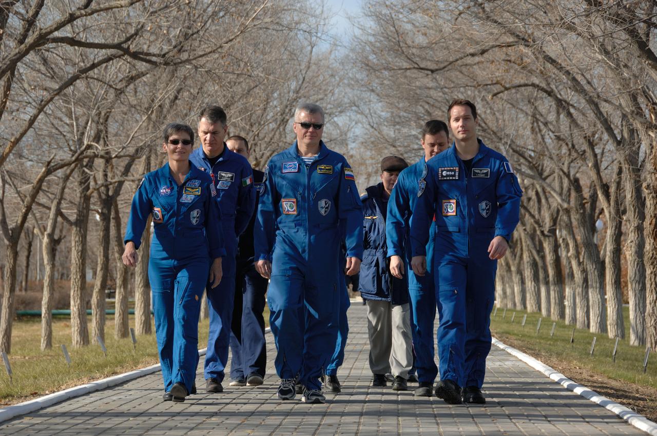At their Cosmonaut Hotel crew quarters in Baikonur, Kazakhstan, Expedition 50-51 crewmembers Peggy Whitson of NASA (left), Oleg Novitskiy of the Russian Federal Space Agency (Roscosmos, center) and Thomas Pesquet of the European Space Agency (right) take a stroll down the Walk of Cosmonauts Nov. 10 as part of their prelaunch activities. They will launch Nov. 18, Baikonur time, on the Soyuz MS-03 spacecraft for a six-month mission on the International Space Station.  NASA/Alexander Vysotsky 