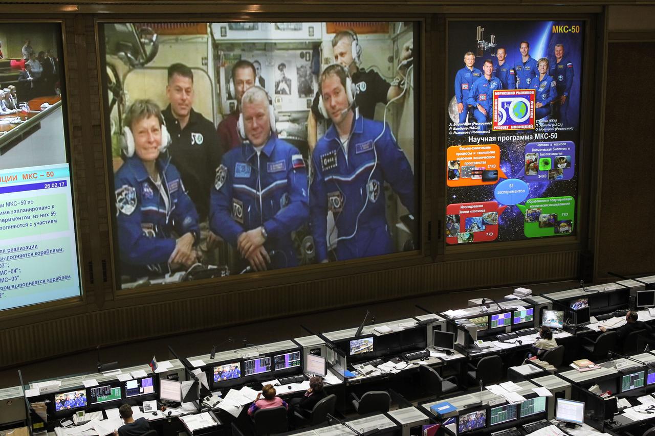 On the front screen in the cavernous control room at the Russian Mission Control Center in Korolev, Russia, the Expedition 50 crewmembers receive congratulatory calls from friends and family Nov. 20 following the arrival of Peggy Whitson of NASA, Oleg Novitskiy of the Russian Federal Space Agency (Roscosmos) and Thomas Pesquet of the European Space Agency at the International Space Station on the Soyuz MS-03 spacecraft. Hatches opened between the Soyuz and the station about two and a half hours after the Soyuz docked to the complex. NASA/Stephanie Stoll