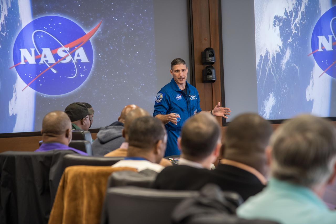 jsc2017e009645 (01/26/2017 --- NASA astronaut Mike Hopkins briefs NFL former players visiting the Johnson Space Center (JSC) during the JSC Tailgate event as part of Super Bowl LI pre-events.