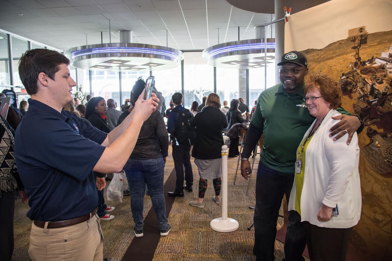 jsc2017e009671 (01/26/2017) --- Former NFL player Emanuel McNeil (New England Patriots and New York Jets) provides a photo opportunity for a Johnson Space Center(JSC) Staff Member in front of the NASA Mars Rover image. Emanuel is touring JSC as part of the Super Bowl tailgate event. The JSC Center Director invited former NFL players during the week leading up to the Super Bowl. NASA Photographer Lauren Harnett.
