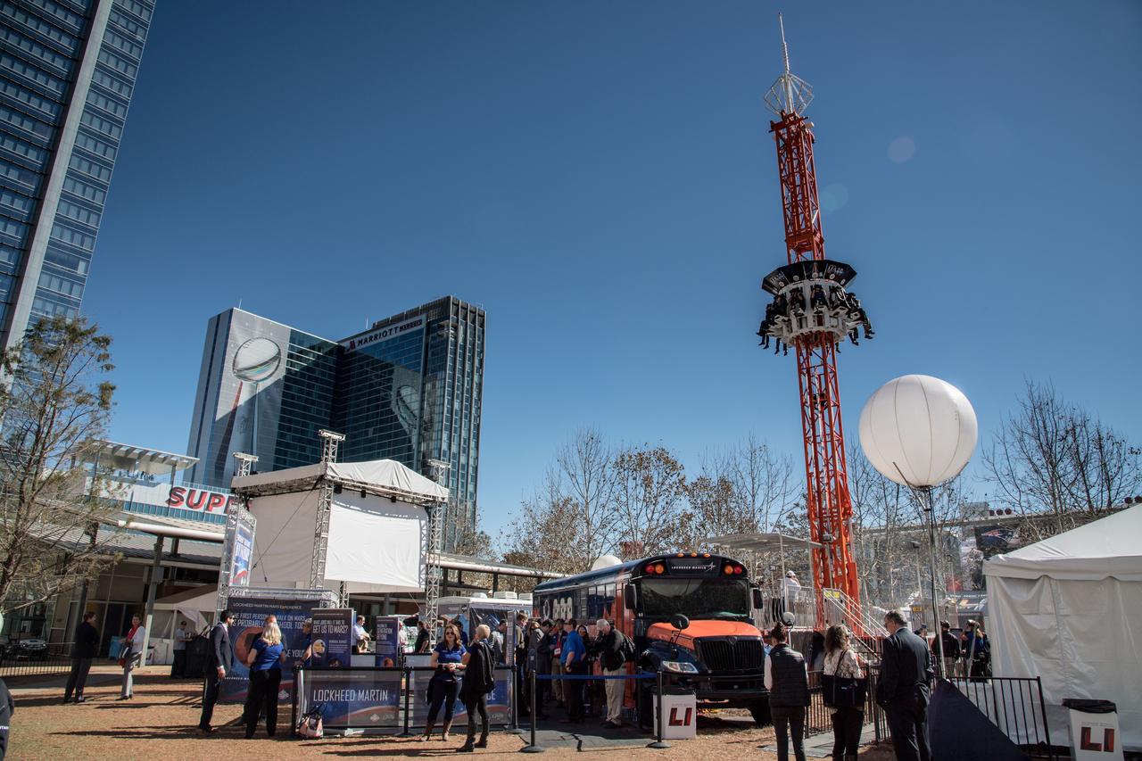 jsc2017e011393 (01/30/2017) --- Space exploration will feature prominently at Super Bowl LIVE, a nine-day fan festival running Jan. 28 through Feb. 5 on Discovery Green, Houston Texas where 100,000 visitors are expected each day. NASA is collaborating with the Houston Super Bowl Host Committee, which is the fan festival organizer, to share NASA’s contributions with the Houston community and to the nation. At NASA's Future Flight, the primary attraction at the free fan festival, riders will take a trip to Mars and back using virtual reality goggles on a 90-foot drop tower ride. Visitors also will get a chance to see several NASA assets that have been transported to downtown Houston for the activities. These assets include: the Orion mockup used for water recovery testing, Space Exploration Vehicle (SEV /Rover), the Driven to Explore mobile exhibit, Mars Science Laboratory – Curiosity Rover - replica, Robonaut 1 (Centaur configuration), EMU space suit presentation unit, Arctic meteorite and astromaterials display, and the Mark III advanced space suit photo-op. Several of NASA’s industry partners sponsoring Future Flight will also have assets on display, and a replica of the James Webb Space Telescope will be located near but not inside the activities on Discovery Green. NASA and industry partner volunteers will be staffing the Future Flight area. NASA PHOTOGRAPHER: Bill Stafford