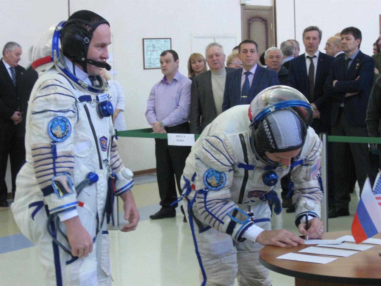 jsc2017e038543 (March 30, 2017) --- At the Gagarin Cosmonaut Training Center in Star City, Russia, Expedition 51 backup crewmember Randy Bresnik of NASA (right) signs in for the start of final crew qualification exams March 30 as his crewmate, Sergey Ryazanskiy of the Russian Federal Space Agency (Roscosmos, left) looks on. They are backups to Fyodor Yurchikhin of Roscosmos and Jack Fischer of NASA, who will launch April 20 on the Soyuz MS-04 spacecraft from the Baikonur Cosmodrome in Kazakhstan for a four and a half month mission on the International Space Station. Credit: NASA/Rob Navias