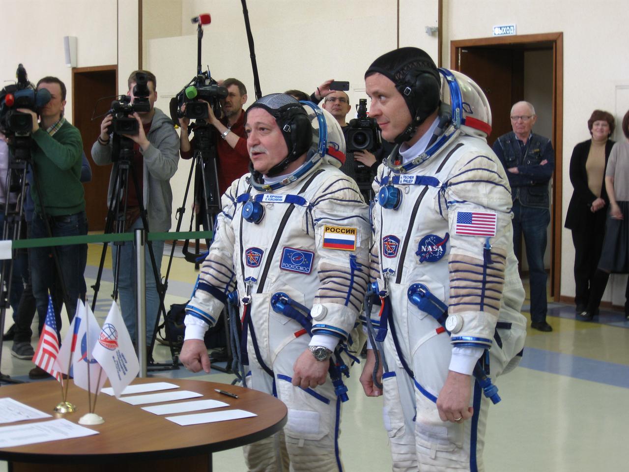 jsc2017e038908 (03/31/2017) --- At the Gagarin Cosmonaut Training Center in Star City, Russia, Expedition 51 crewmembers Fyodor Yurchikhin of the Russian Federal Space Agency (Roscosmos, left) and Jack Fischer of NASA (right) report to Russian state commission officials March 31 at the start of the second of two days of final qualification exams. Yurchikhin and Fischer will launch April 20 on the Soyuz MS-04 spacecraft from the Baikonur Cosmodrome in Kazakhstan for a four and a half month mission on the International Space Station. Expedition 51 Photo: Rob Navias/NASA.