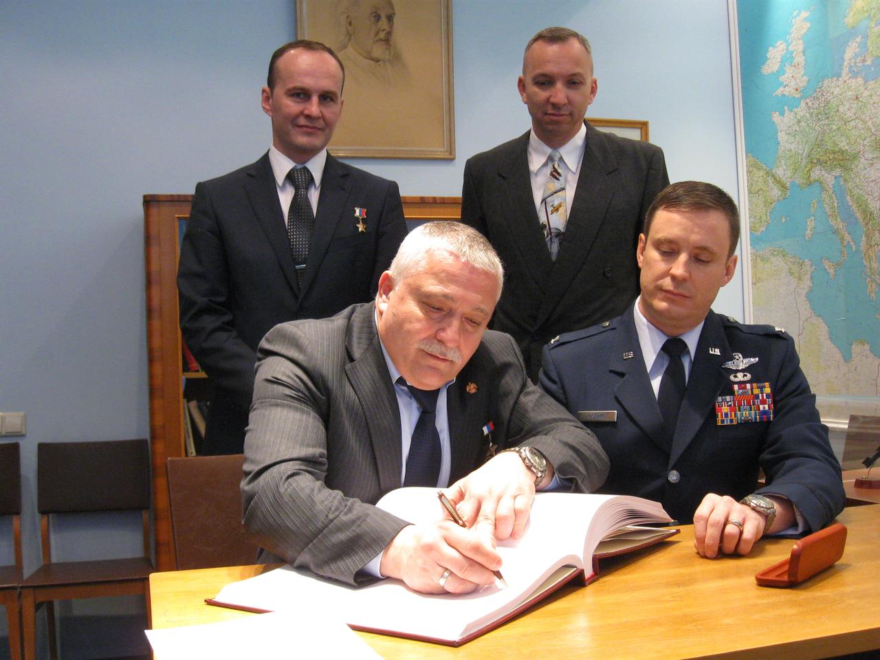 jsc2017e039452 (04/03/2017) --- At the Gagarin Museum at the Gagarin Cosmonaut Training Center in Star City, Russia, Expedition 51 prime crewmember Fyodor Yurchikhin of the Russian Federal Space Agency (Roscosmos, front row, left) signs a commemorative book in a traditional ceremony April 3. Looking on are his crewmate, Jack Fischer of NASA (front row, right) and the backup crewmembers in the back row, Sergey Ryazanskiy of Roscosmos (back row, left) and Randy Bresnik of NASA (back row, right). Yurchikhin and Fischer will launch April 20 on the Soyuz MS-04 spacecraft from the Baikonur Cosmodrome in Kazakhstan for a four and a half month mission on the International Space Station. Photo: NASA/Rob Navias.