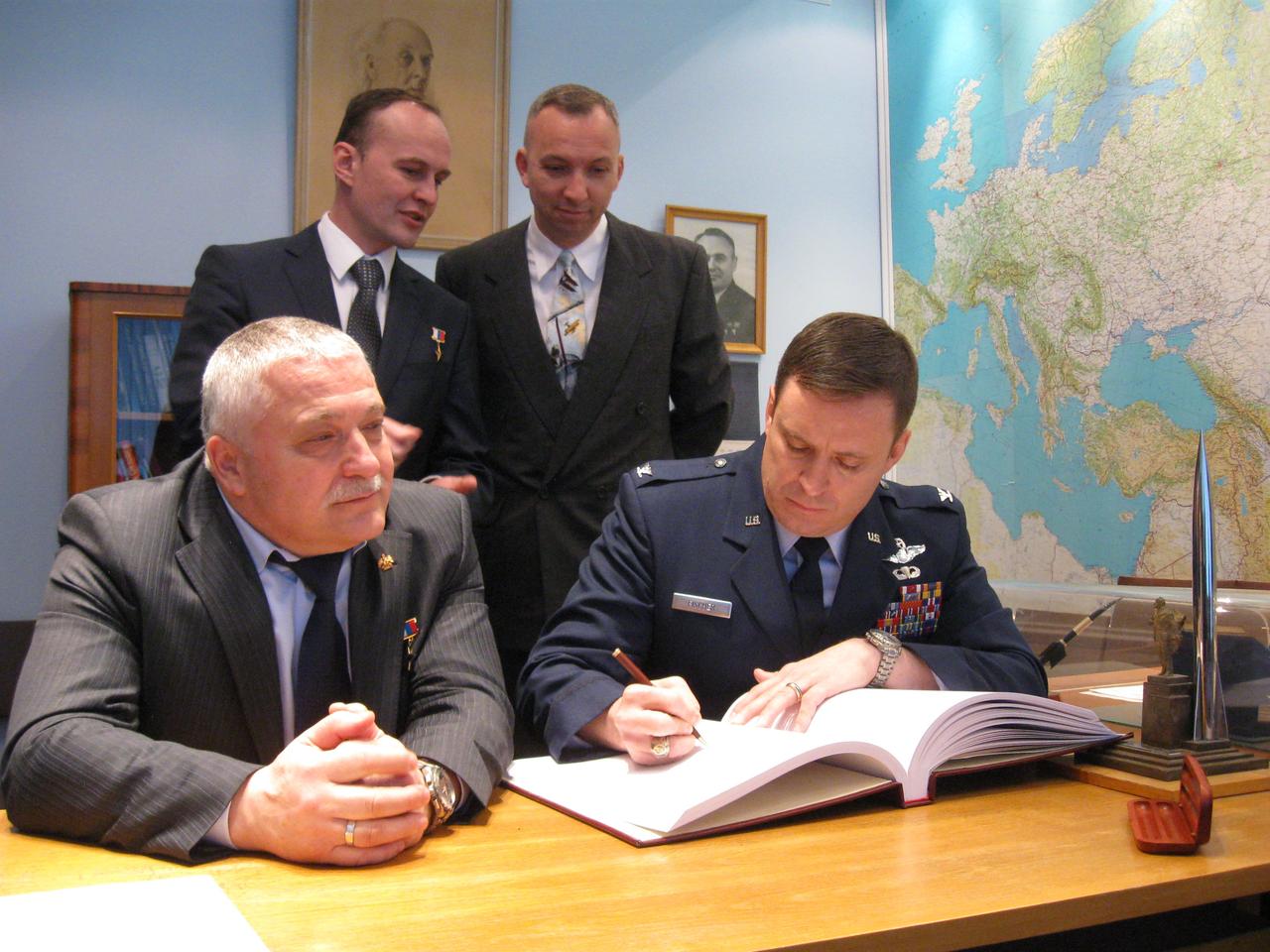 jsc2017e039453 (04/03/2017) --- At the Gagarin Museum at the Gagarin Cosmonaut Training Center in Star City, Russia, Expedition 51 crewmember Jack Fischer of NASA (front row, right) signs a commemorative book in a traditional ceremony April 3. Looking on are crewmate Fyodor Yurchikhin of the Russian Federal Space Agency (Roscosmos, front row, left) and in the back row, backup crewmembers Sergey Ryazanskiy of Roscosmos (back row, left) and Randy Bresnik of NASA (back row, right). Fischer and Yurchikhin will launch April 20 on the Soyuz MS-04 spacecraft from the Baikonur Cosmodrome in Kazakhstan for a four and a half month mission on the International Space Station. Photo: NASA/Rob Navias