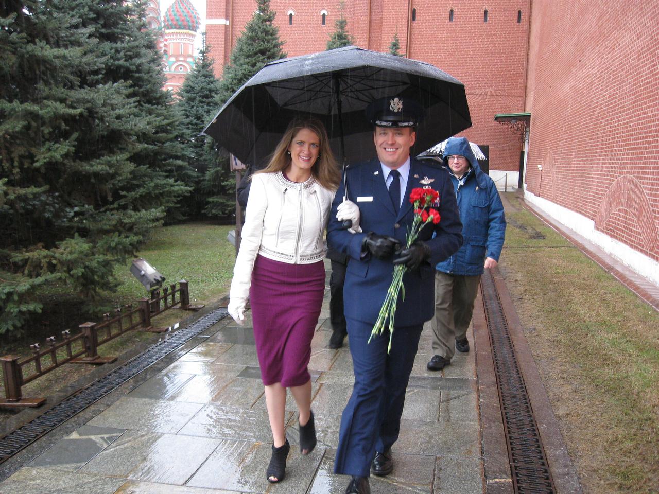 jsc2017e039457 (04/03/2017) --- Walking in a driving rainstorm, Expedition 51 crewmember Jack Fischer of NASA (right) and his wife Elizabeth make their way along the Kremlin Wall in Red Square in Moscow April 3 to lay flowers where Russian space icons are interred. Fischer and Fyodor Yurchikhin of the Russian Federal Space Agency (Roscosmos) will launch April 20 on the Soyuz MS-04 spacecraft from the Baikonur Cosmodrome in Kazakhstan for a four and a half month mission on the International Space Station Photo: .NASA/Rob Navias.