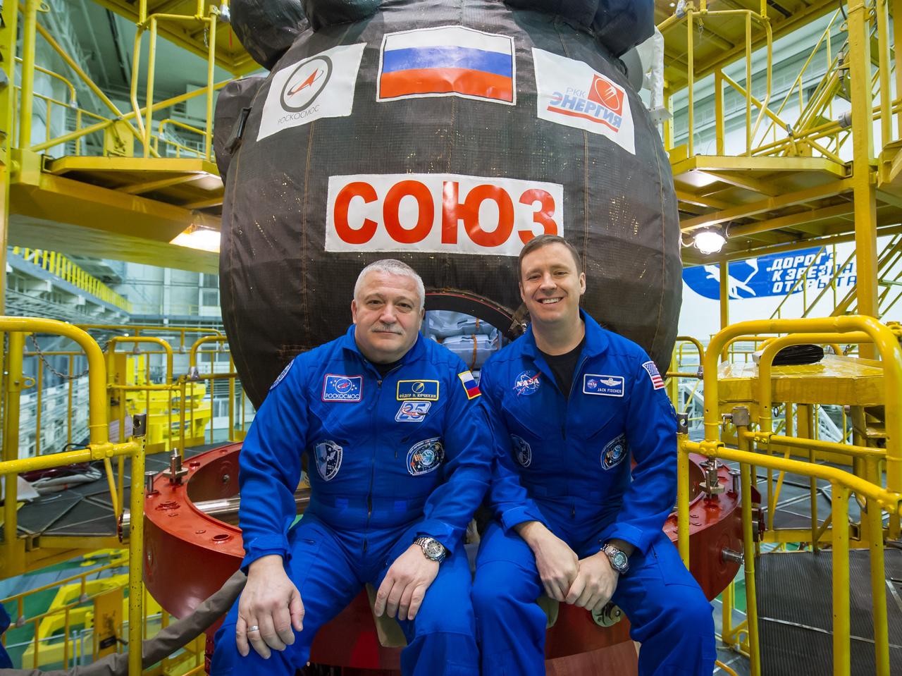 jsc2017e040282 (April 6, 2017) --- In the Integration Building at the Baikonur Cosmodrome in Kazakhstan, Expedition 51 crewmembers Fyodor Yurchikhin of the Russian Federal Space Agency (Roscosmos, left) and Jack Fischer of NASA (right) pose for pictures April 6 in front of their Soyuz MS-04 spacecraft as part of pre-launch preparations. Fischer and Yurchikhin will launch April 20 on the Soyuz MS-04 spacecraft for a four and a half month mission on the International Space Station. NASA/Gagarin Cosmonaut Training Center/Andrey Shelepin