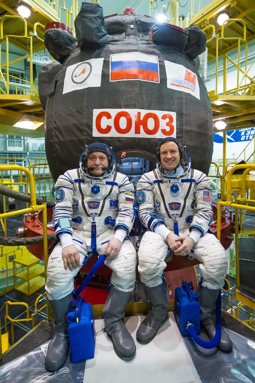 jsc2017e040289 (April 6, 2017) --- In the Integration Building at the Baikonur Cosmodrome in Kazakhstan, Expedition 51 crewmembers Fyodor Yurchikhin of the Russian Federal Space Agency (Roscosmos, left) and Jack Fischer of NASA (right) pose for pictures April 6 in front of their Soyuz MS-04 spacecraft as part of pre-launch training preparations. Fischer and Yurchikhin will launch April 20 on the Soyuz MS-04 spacecraft for a four and a half month mission on the International Space Station. NASA/Gagarin Cosmonaut Training Center/Andrey Shelepin